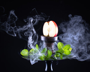 fruit hookah with tobacco, apple, mint and smoke on black background