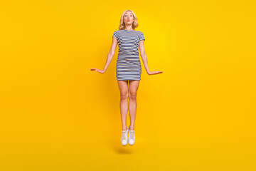 Full length body size photo woman jumping up with pouted lips isolated vibrant yellow color...