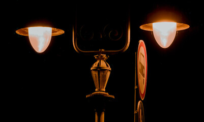 two lamps on the street on a black background