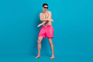 Full body photo of young cheerful man happy positive smile dance disco trip isolated over blue color background