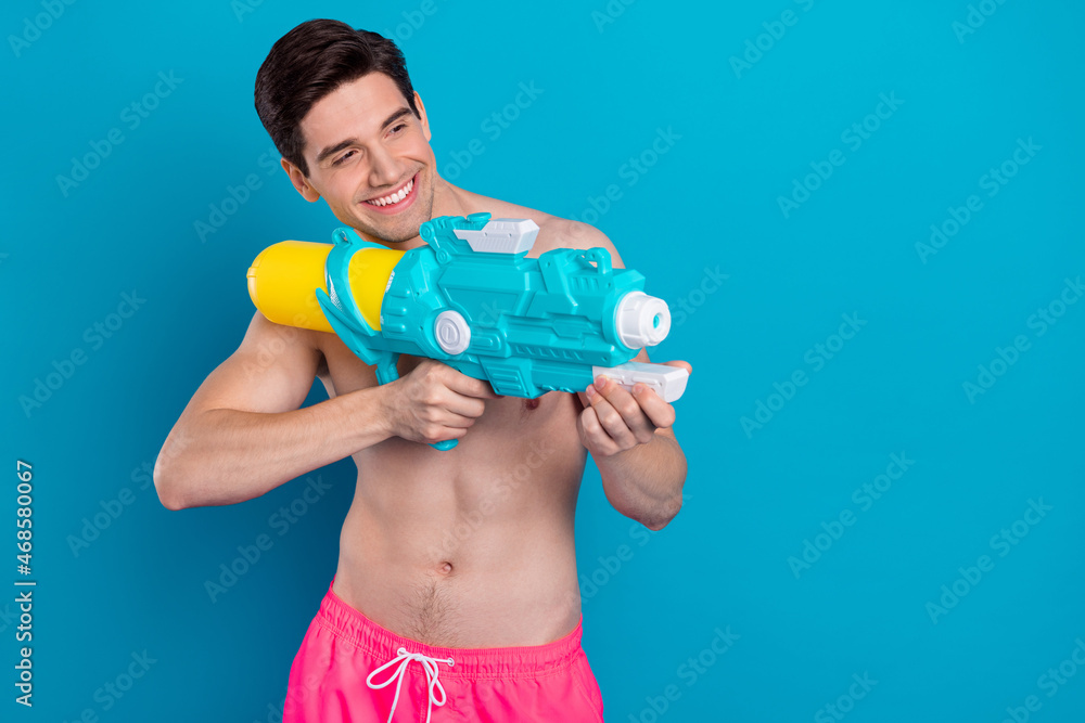 Sticker Profile photo of positive guy hold pump gun aim shot wear swimwear shorts isolated blue color background