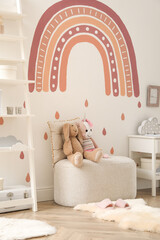 Child's room interior with rainbow painting on wall