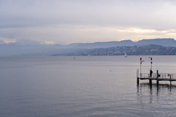Pier at lake Zürich on a cloudy autumn day. Photo taken October 30th, 2021, Zurich, Switzerland.