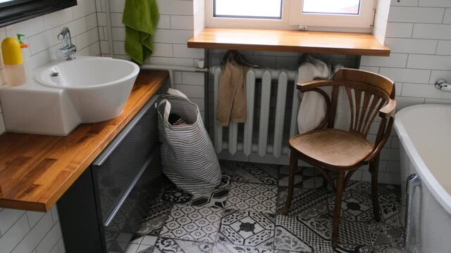 Bathroom interior with toilet bowl, mirror with bathtub sink and shower with window and heating radiator