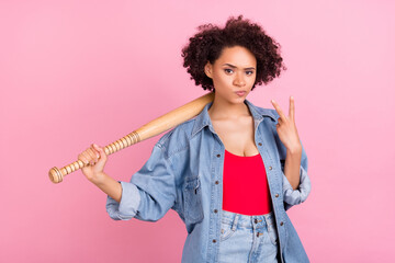 Photo of cool self-assured hipster african lady show v-sign hold bat wear jeans jacket isolated pink color background