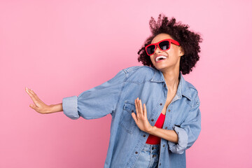 Photo of young happy dark skin funky joyful woman wear sunglass dance isolated on pink color background