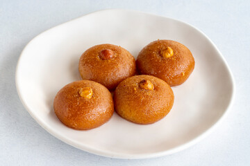 Delicious turkish sweet sekerpare on served. Traditional Turkish dessert sekerpare or badempare on a white background. Close up