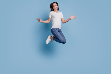 Portrait of crazy carefree lady jump have fun enjoy weekend on blue background