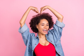 Photo of african flirty coquette lady hands show heart blink eye wear denim jacket isolated pink...