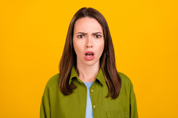 Fototapeta premium Photo of shocked unhappy young upset woman face reaction bad news isolated on yellow color background