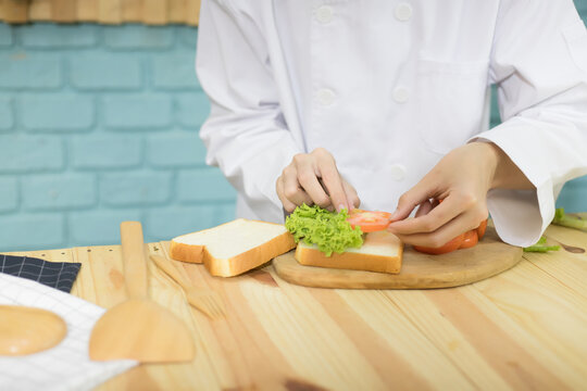 Chef Is Making Sandwiches In The Kitchen.