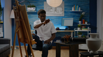 Fototapeta na wymiar Black artist analyzing vase for drawing design in artwork creative studio. African american man using authentic inspiration for professional masterpiece and fine art. Artistic person