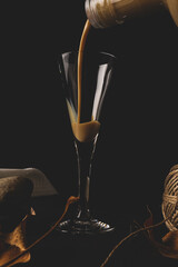 vertical shot of cream liqueur falling into a crystal goblet

