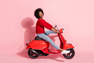 Fototapeta na wymiar Profile side view portrait of nice funny cheerful girl riding moped without legs having fun isolated over pink pastel color background