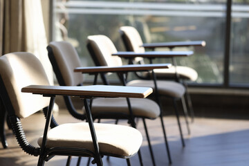 Fototapeta na wymiar Empty chairs standing in conference room closeup