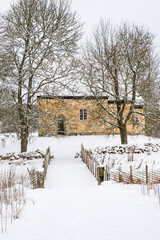 Old Swedish church from 12th century in a snowy countryside