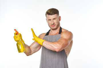 cheerful man in apron detergent posing muscles