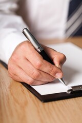 Businessman Taking Notes on a Clipboard