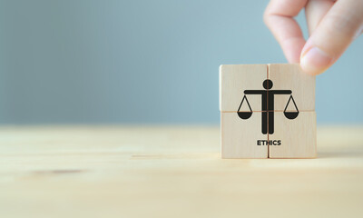 Business ethics concept. Business moral principles concept.  Hand holds the wooden cubes with...