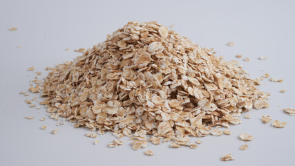 Fototapeta na wymiar Cereals, oatmeal heap isolated on white table background