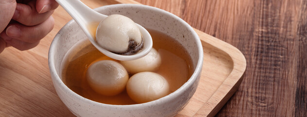Fototapeta na wymiar Sesame big tangyuan with syrup soup.