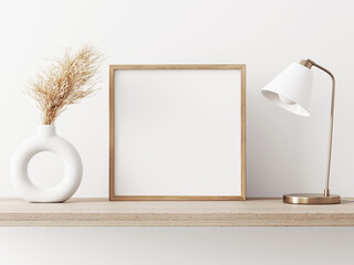 Empty square frame mockup in warm neutral minimalist interior with dried pampas grass, trendy vase and brass desk lamp on wooden beige brown shelf on white wall background. Illustration, 3d rendering