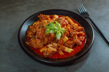 Korean food Spicy Stir-fried Chicken tteokbokki dish on black plate