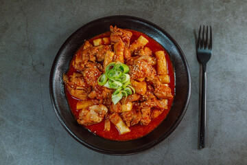 Korean food Spicy Stir-fried Chicken tteokbokki dish on black plate