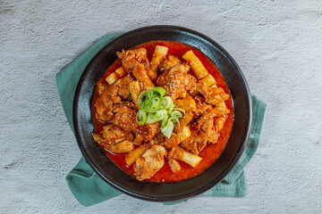 Korean food Spicy Stir-fried Chicken tteokbokki dish on black plate