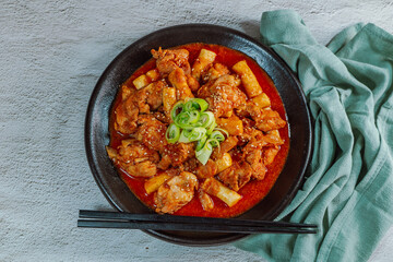 Korean food Spicy Stir-fried Chicken tteokbokki dish on black plate