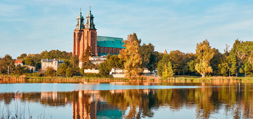 Cathedral in Gniezno town, Poland, on a bright day in Summer reflected in water