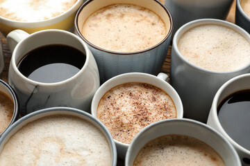 Many cups of different coffees on table, closeup