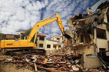 Excavators working on huge demolition site. Construction machinery demolishing buildings. Building...