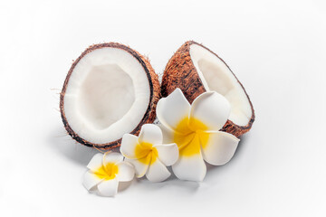 Fototapeta na wymiar Coconut, plumeria flowers on white. Travel, organic cosmetics, summer sale concept.