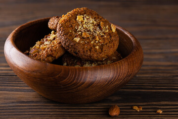Vegan oatmeal cookies with quinoa, carrots and almonds in a wooden bowl. Sugar, gluten and lactose free.