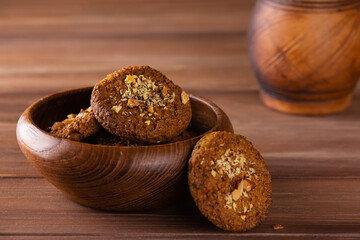 Oatmeal cookies with quinoa and carrots in a wooden plate. Sugar, gluten and lactose free and vegan.