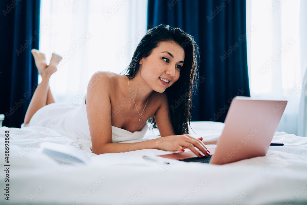 Poster smiling asian freelancer watching received video on digital laptop computer using hotel wifi connect