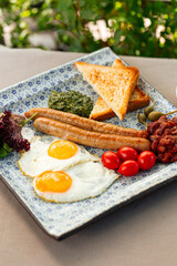 Closeup on served english breakfast in terrace cafe