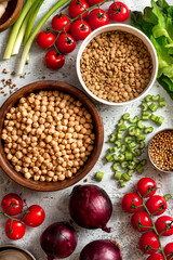 Various vegetables, spices and chickpeas on a gray concrete background top view. Vegan food, healthy eating concept. Food background. Cooking food.