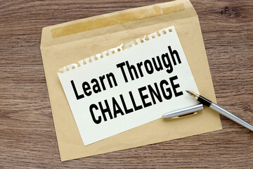 Learn through challenge, Blank postcard and envelope on old wooden background