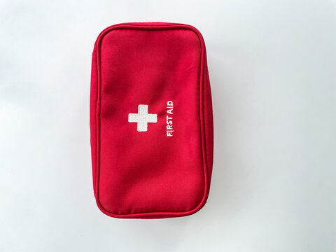 Red first aid kit isolated on the white background.