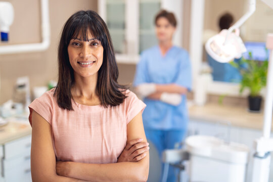 Portrait of smiling caucasian female patient looking at camera at modern dental clinic