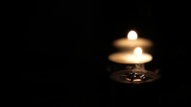  candles slowly burning down at night 