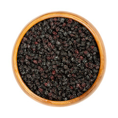 Dried elderberries in a wooden bowl. Ripe Sambucus berries. Elder or elderberry. Raw berries are not edible, but are used for steeping in hot teas in traditional medicine to provide relief from colds.