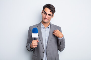 young handsome man looking arrogant, successful, positive and proud. presenter with microphone
