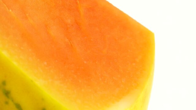 4K Half ripe papaya fruit with seeds. Fragrant tropical fruit pulp. Sweet fisolated resh papaw, raw vegan food isolated on white background