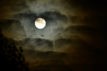 Naklejka na ściany i meble beautiful full moon surrounded by clouds, night sky and stars