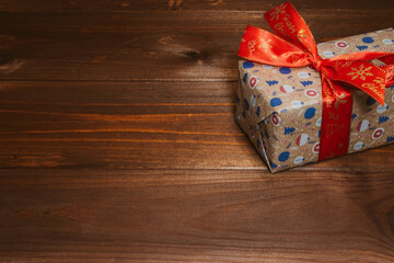 Christmas background with gift box on wooden desk. Place for text