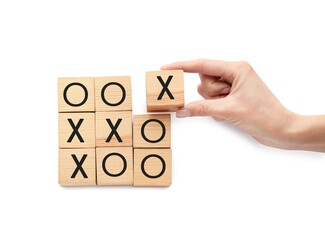 Woman playing tic tac toe game on white background, top view