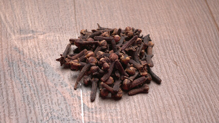 Cloves on vintage wooden background.